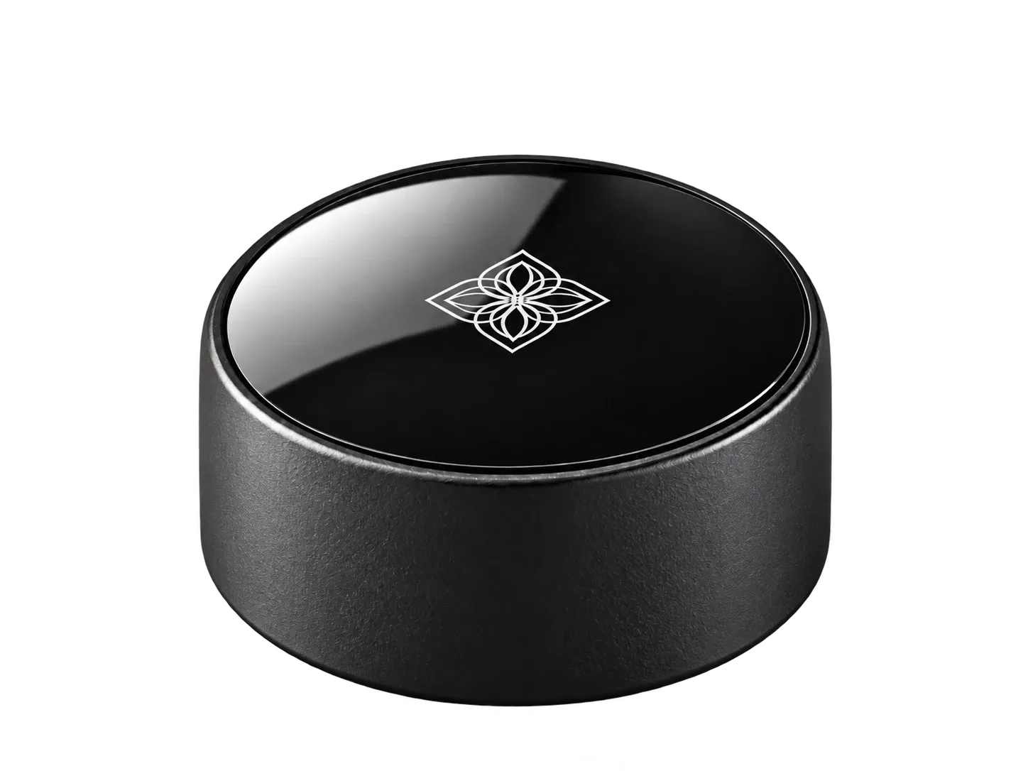 Bloom Pod: a round matte black puck with a glossy top and the Bloom mark